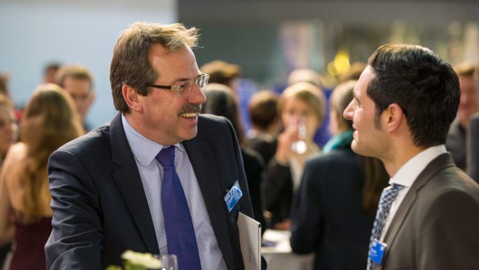 A scholarship sponsor talking to a scholar